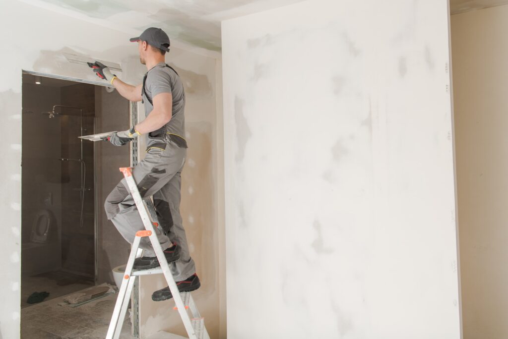 Worker Patching Drywall